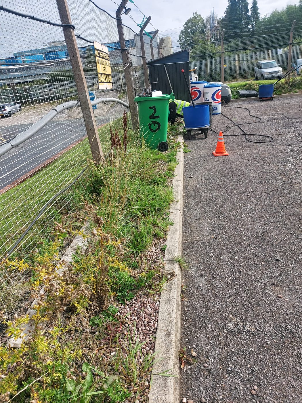 Commercial site verge and fence line during grounds maintenance