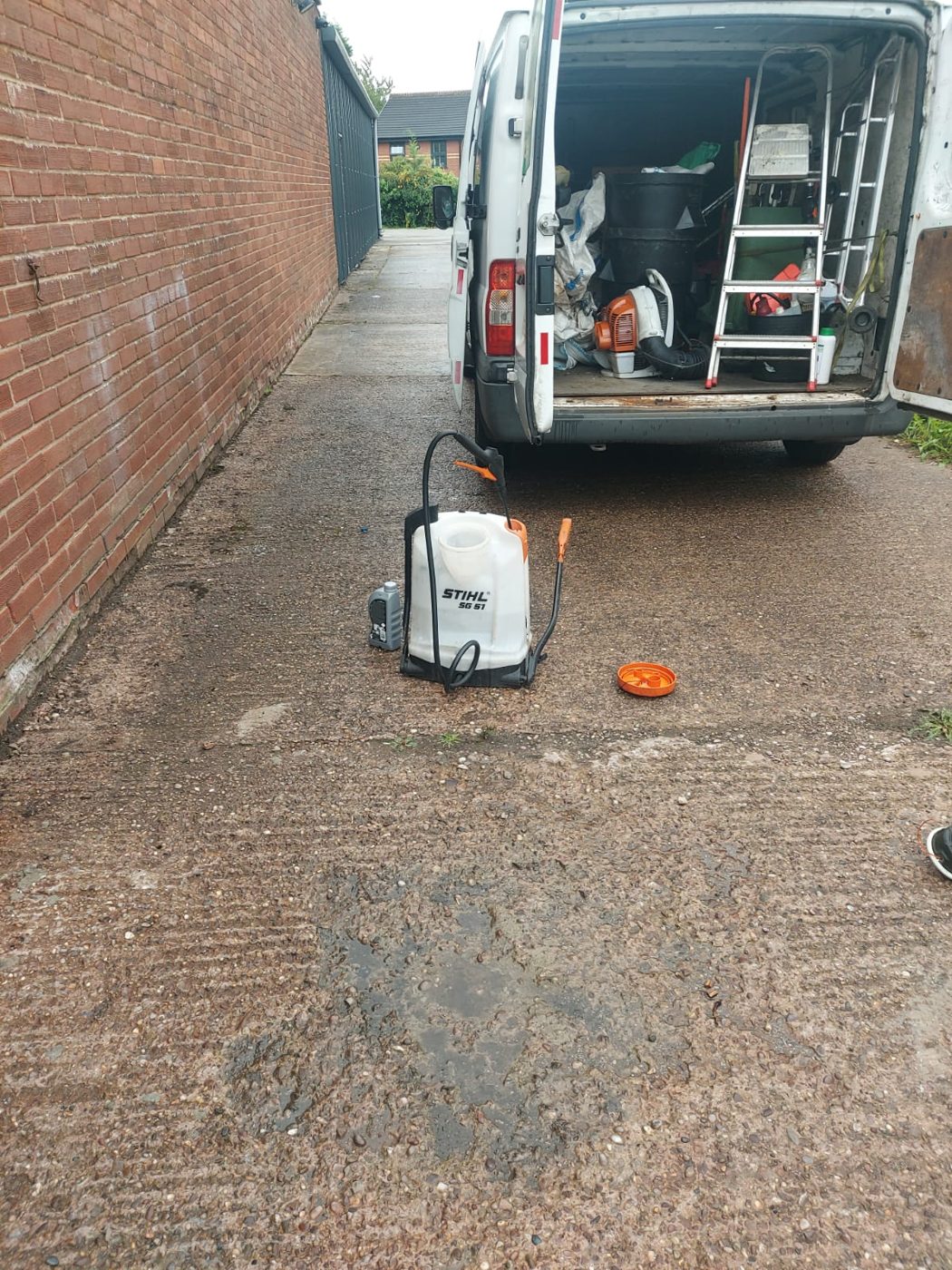 Grounds maintenance sprayer and equipment beside the open team van
